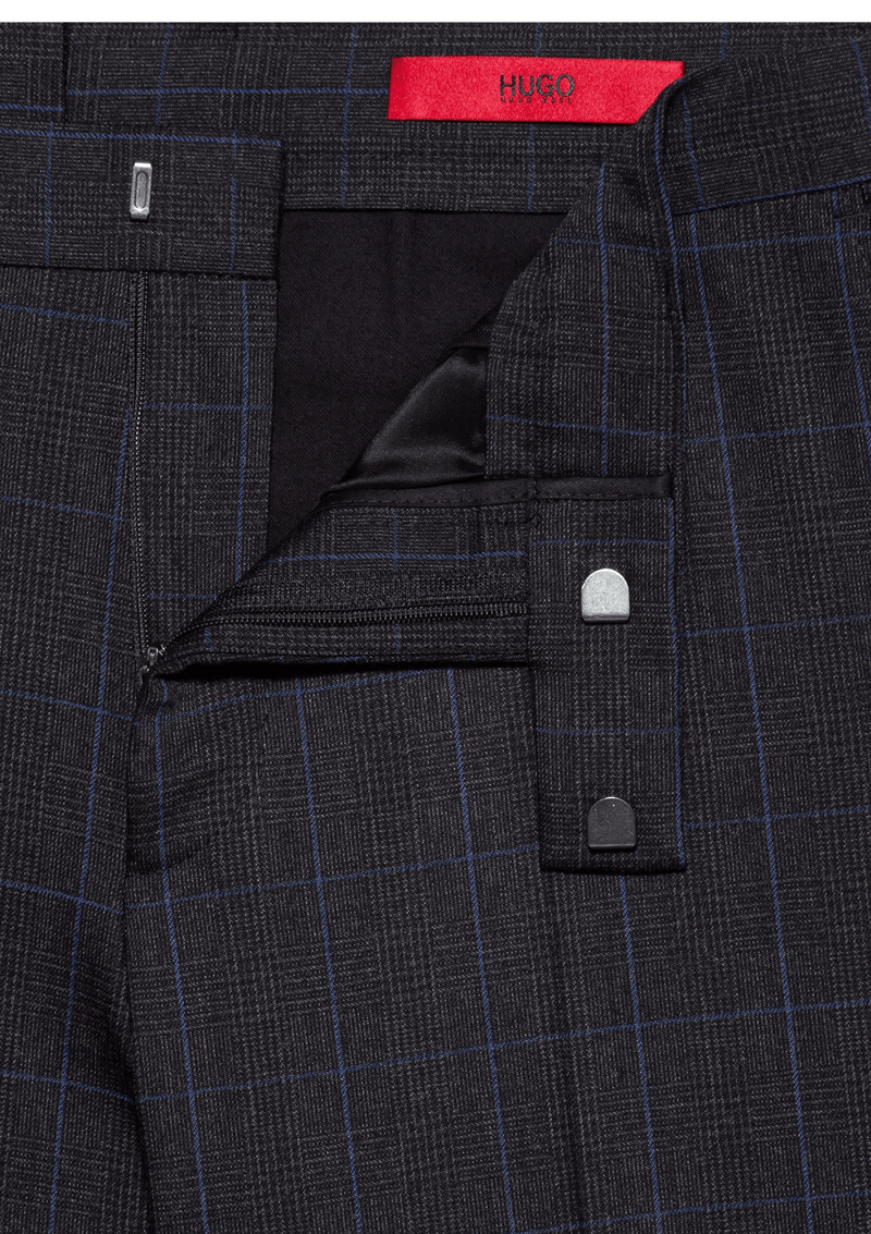 a close up of the hugo slim fit anfred suit trousers in charcoal showing the fine check print through the fabric