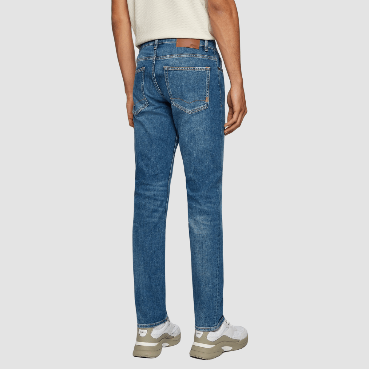the back of the hugo boss deleware jeans with two pockets on the back hips and a leather embossed label on the waistband