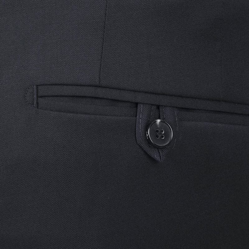 a close up of the button closed back hip pocket on the mens suit trouser in dark navy blue 