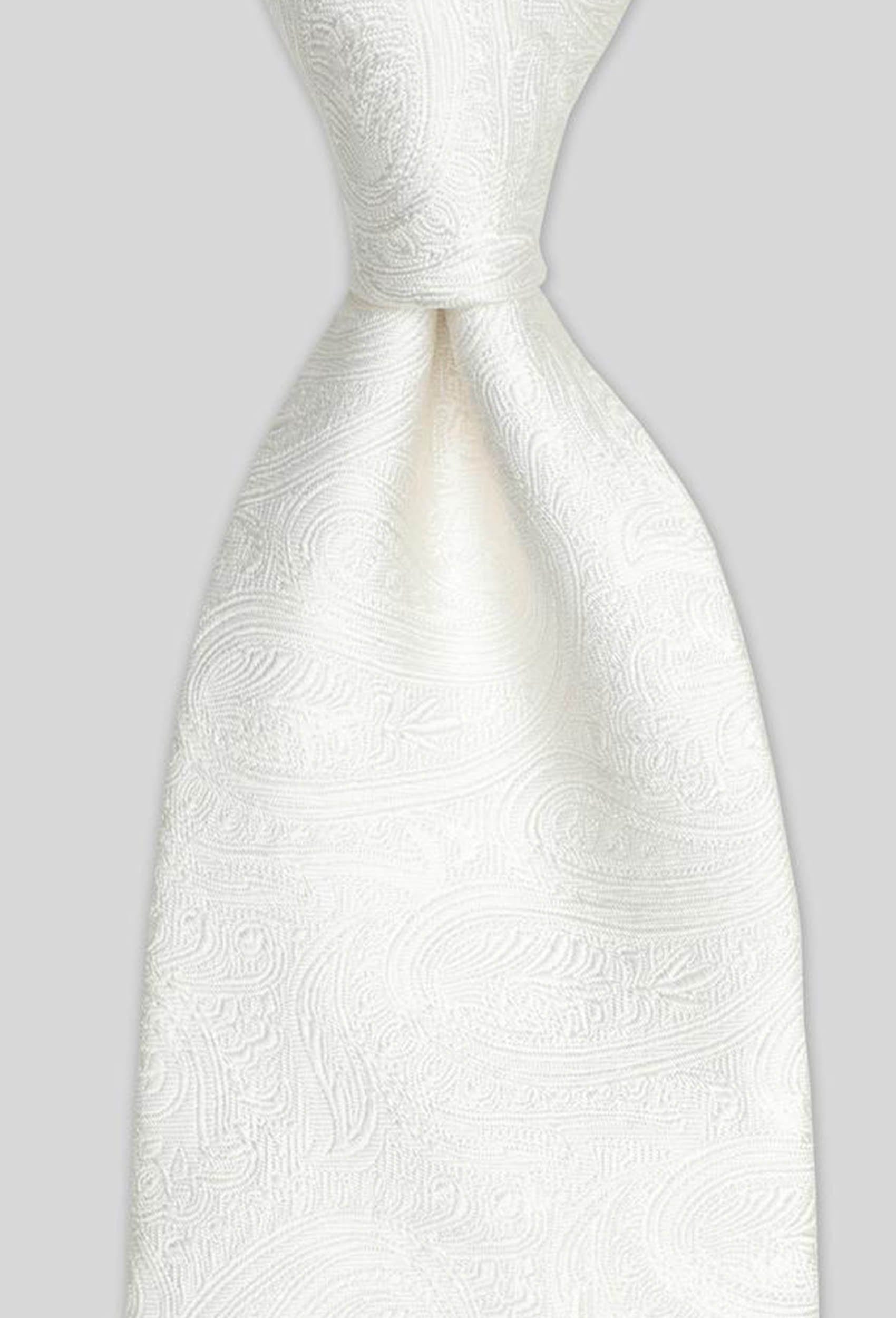 a close up view of the Joe Black paisley jacquard tie in ivory PJAF000017 tied in a Windsor knot
