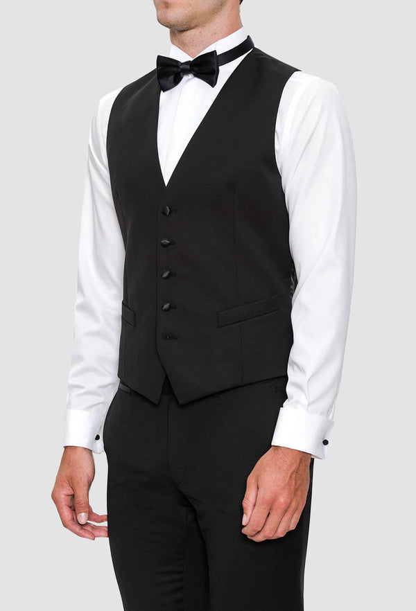a model wears the joe black slim fit mail vest in black pure wool