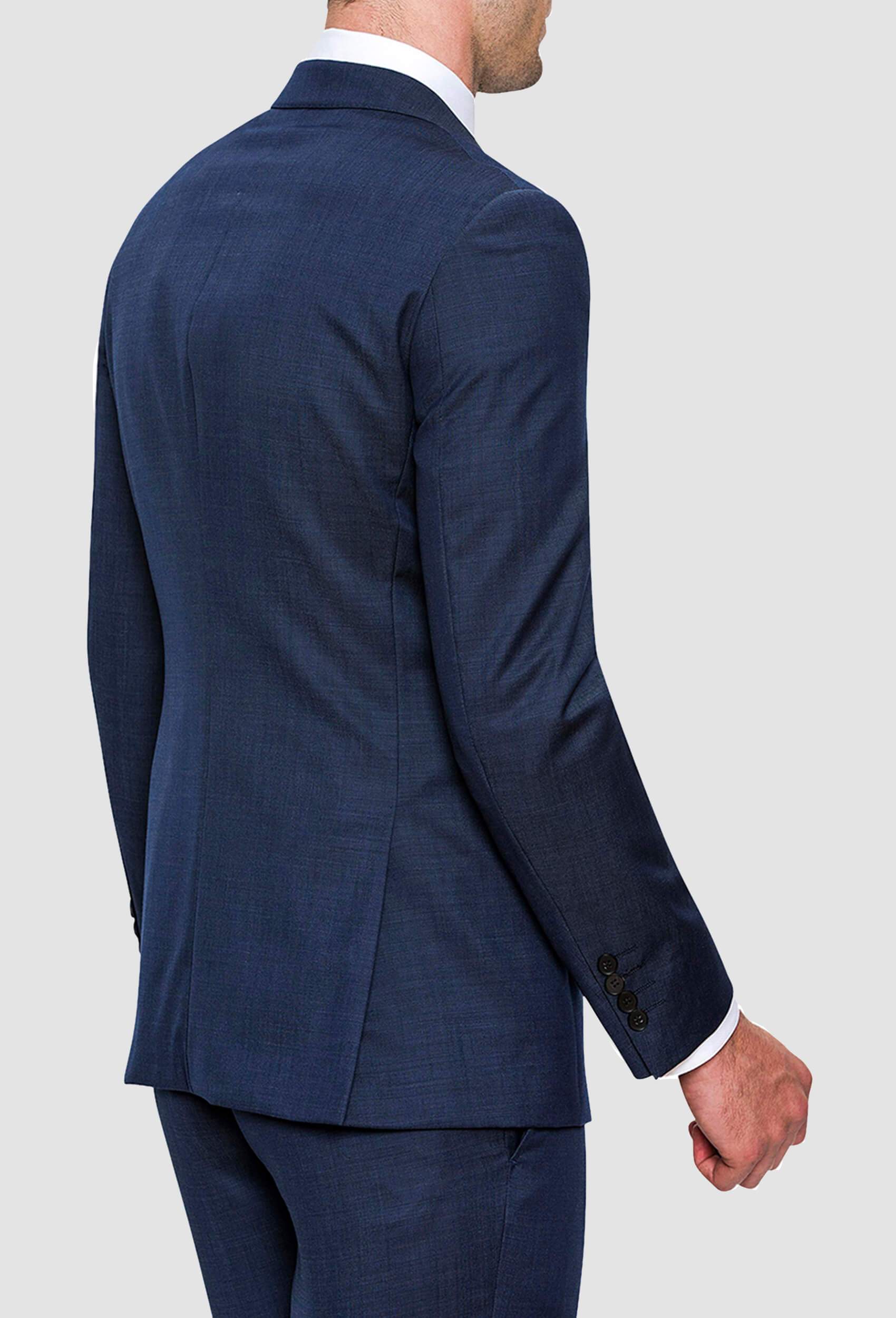 a man wears the joe black mission suit in a textured navy wool 
