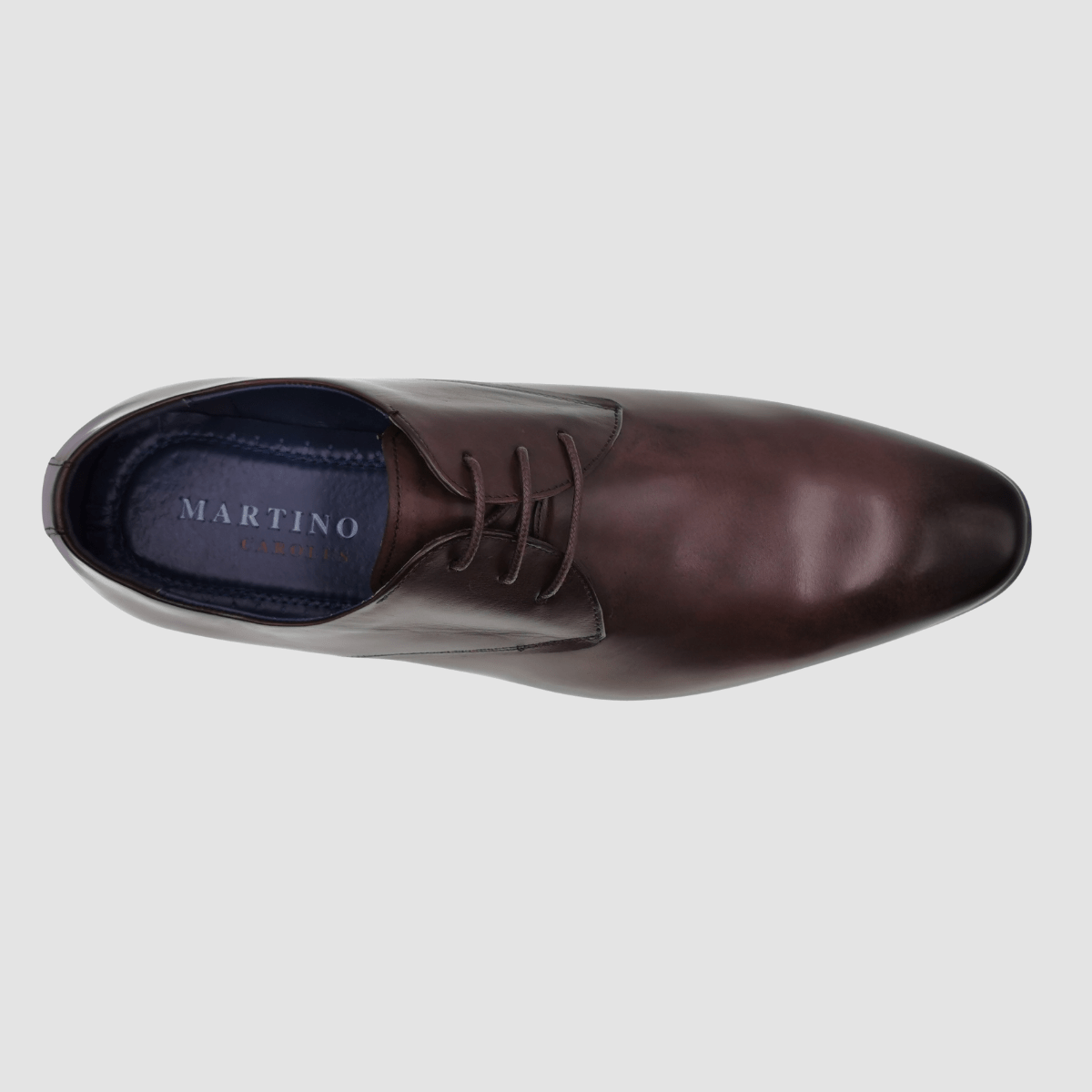 shows the smooth finish of the dark brown leather a simple lace up design and black leather inner