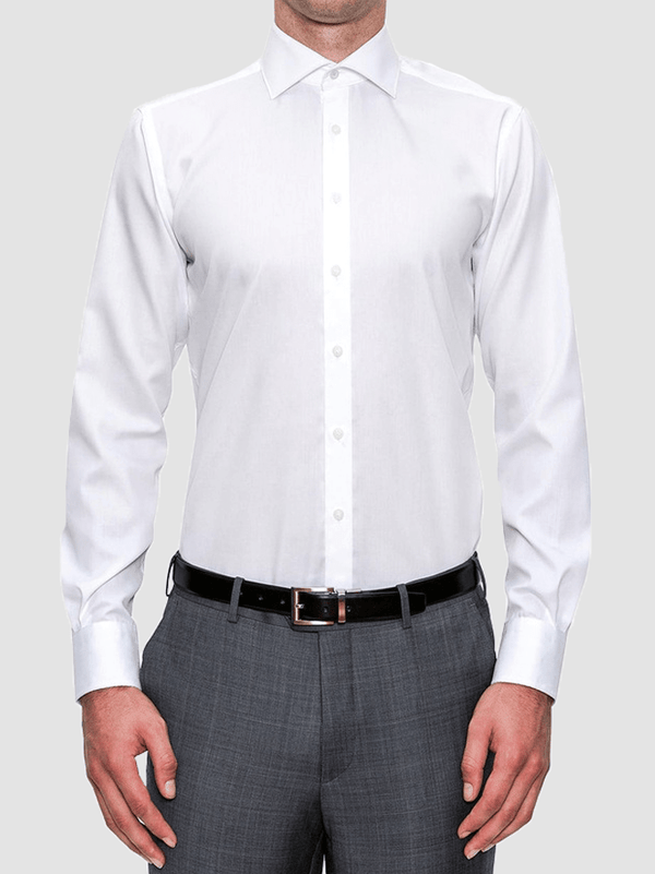 a model wears the preston mens shirt by cambridge clothing, a crisp 8 button front white business shirt with long sleeves and regular cuffs.