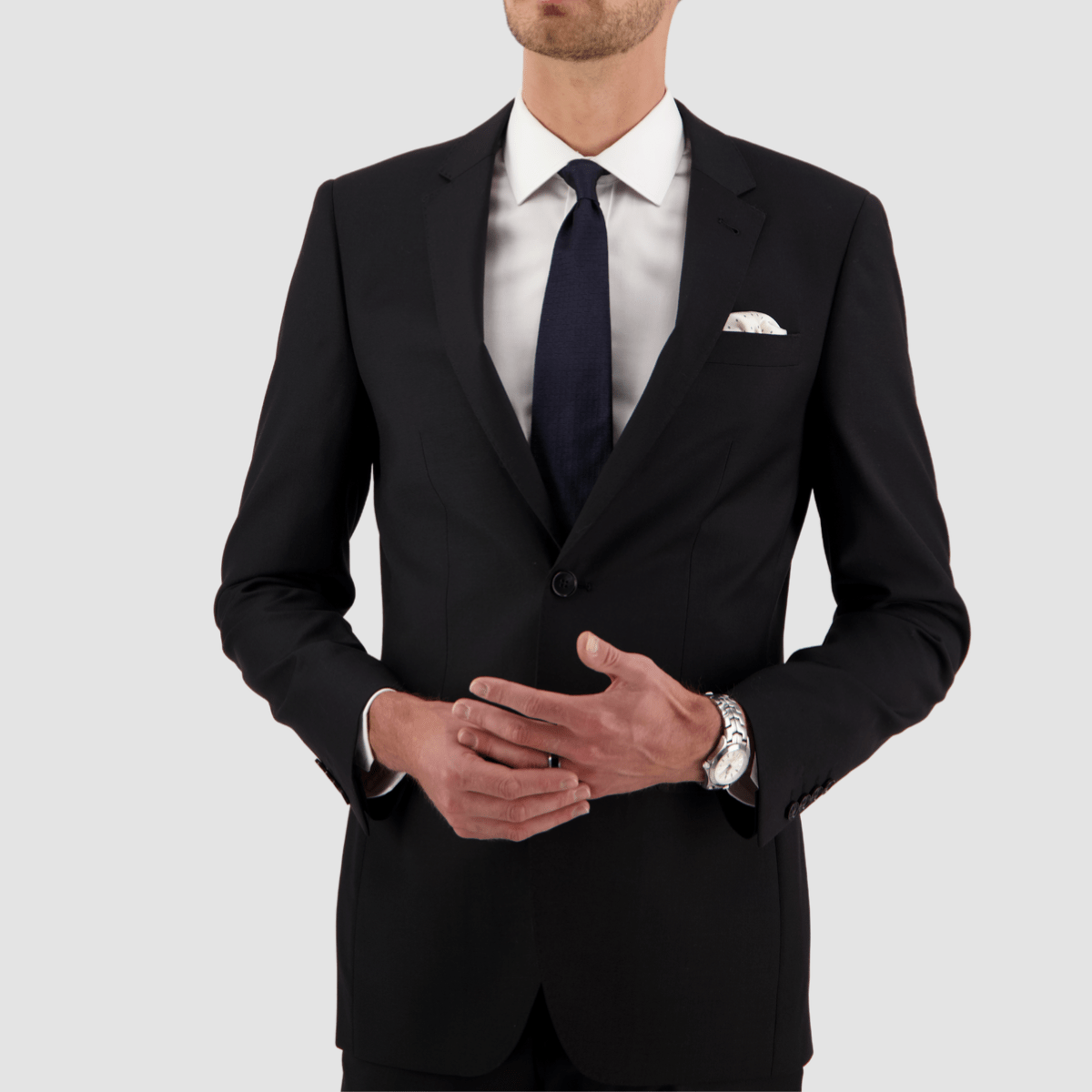Black travel‑finish wool suit by Savile Row, tailored in Super 110’s Merino with a clean, structured fit.