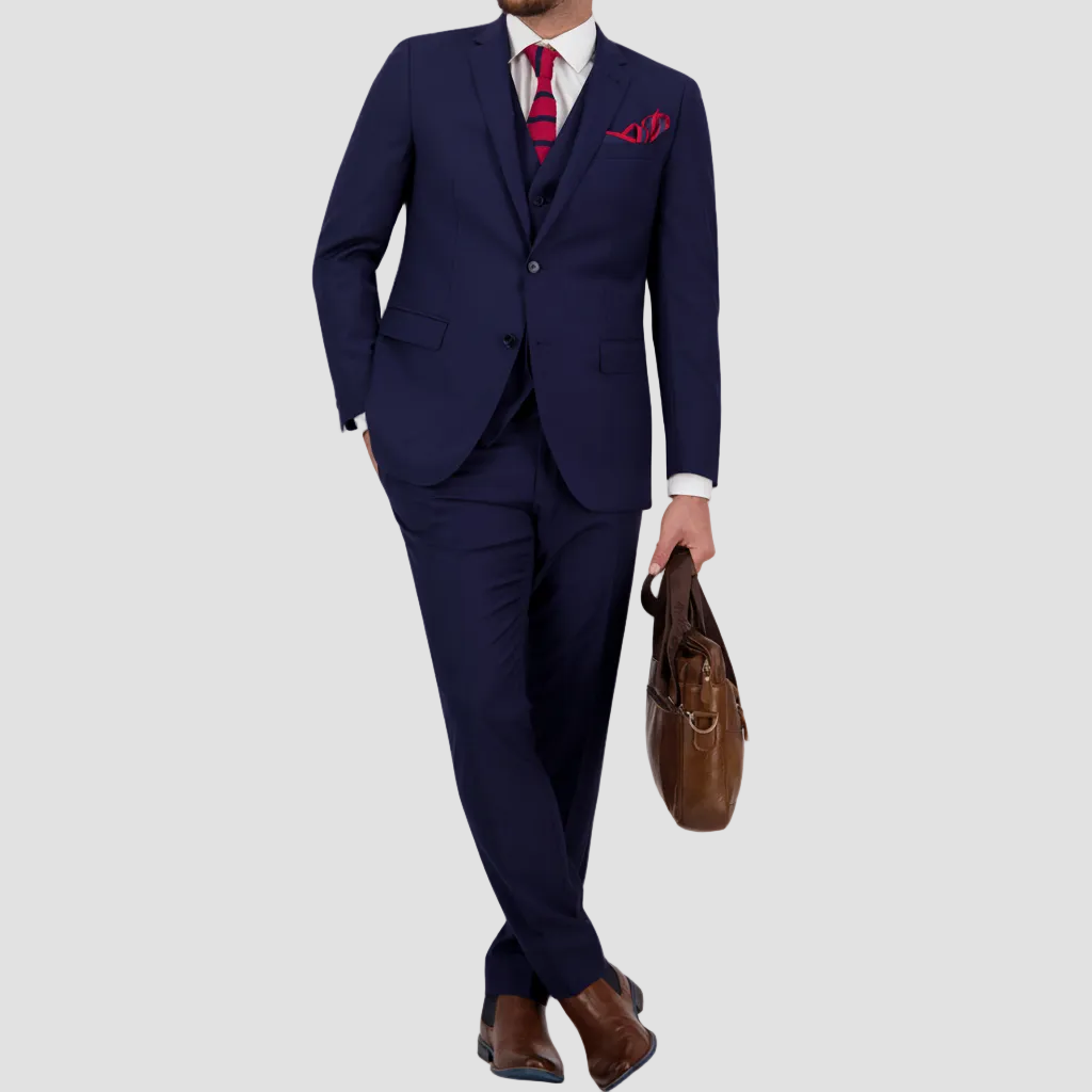 Marine blue Australian merino wool suit with a white shirt, red tie and pocket square, and brown leather boots.