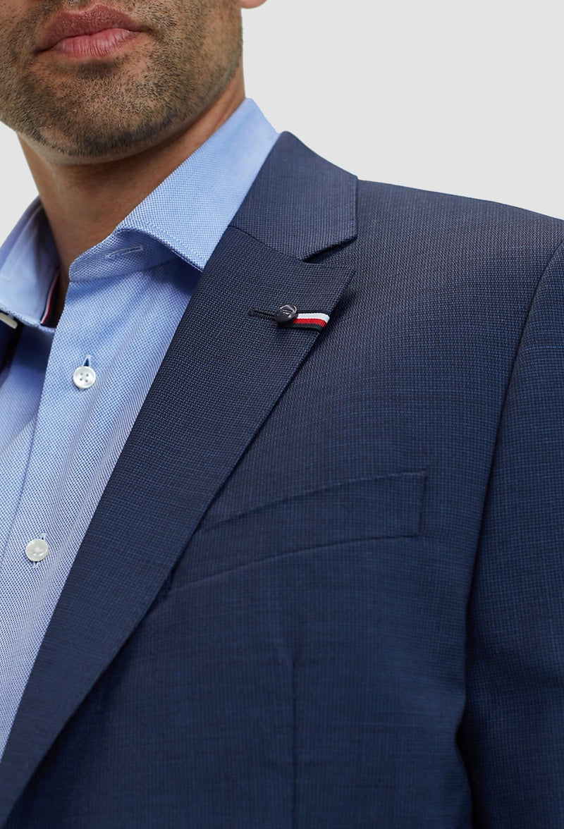 A close up view of the lapel details on the Tommy Hilfiger slim fit virgin wool suit blazer in navy blue including the notched lapel