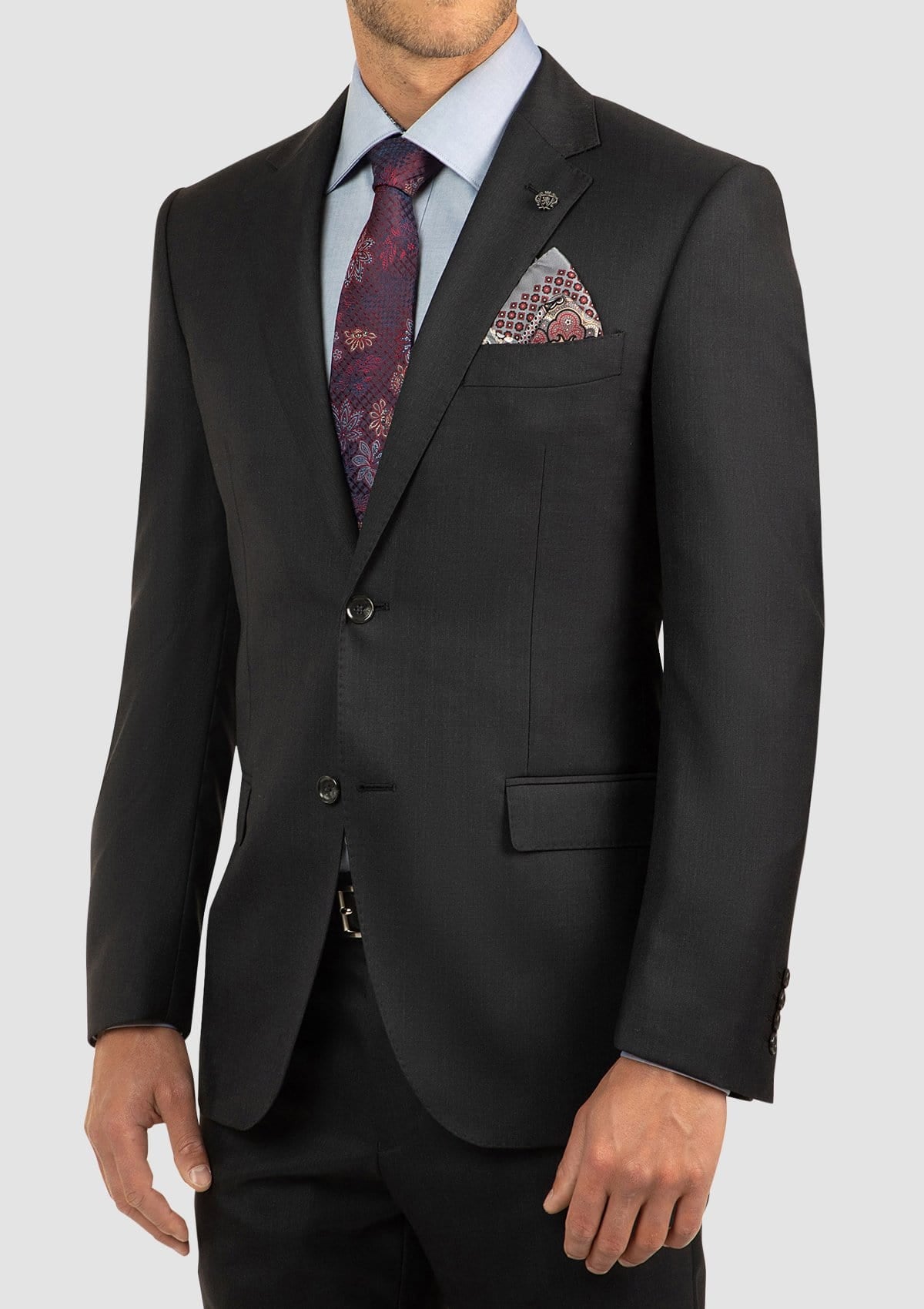 a close view of the cambridge classic fit morse suit jacket in a charcoal pure wool styled with blue shirt and printed tie